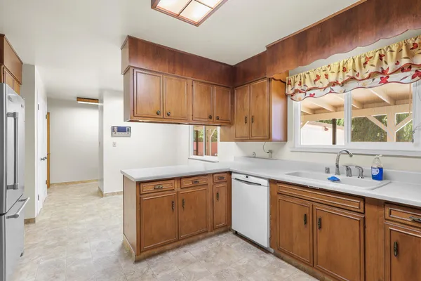 a kitchen with a sink cabinets and window