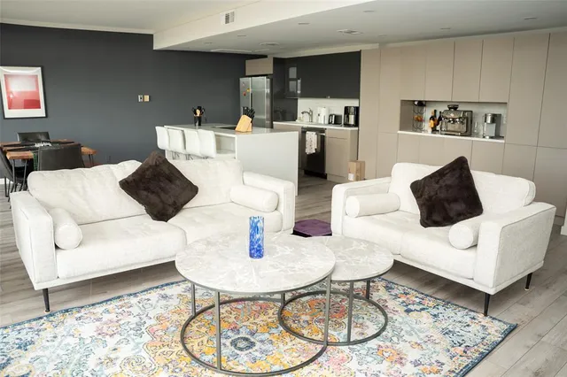 a living room with furniture and kitchen view