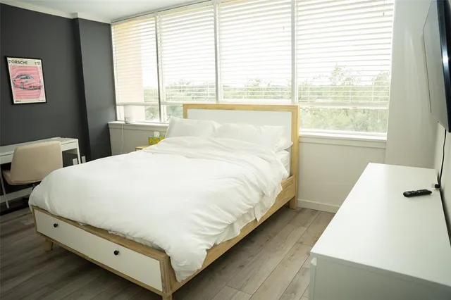 a large bed sitting in a bedroom next to a window