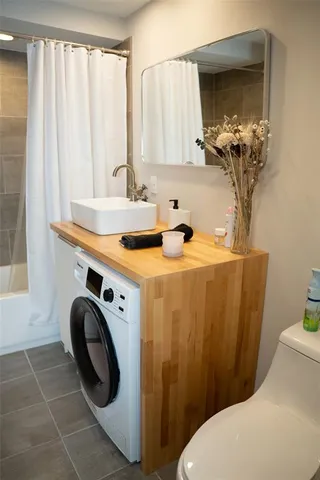 a bathroom with a sink a toilet and a mirror
