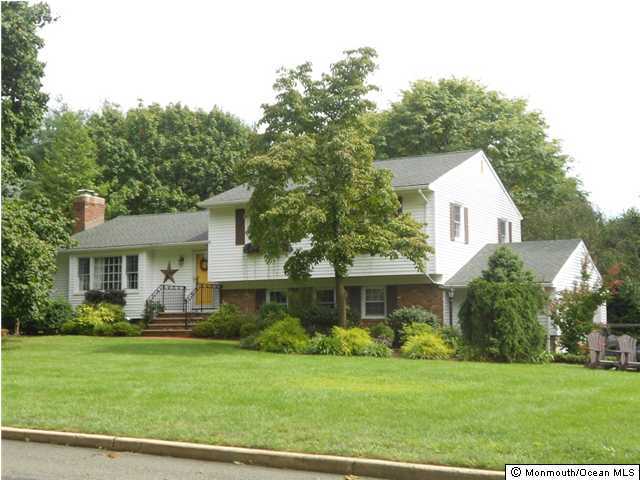 18 Pelican Road Middletown, NJ 07748 - Photo 1 of 3 a front view of a house with a yard and trees