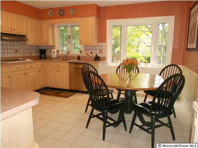 18 Pelican Road Middletown, NJ 07748 - Photo 3 of 3 a kitchen with a dining table chairs and white appliances