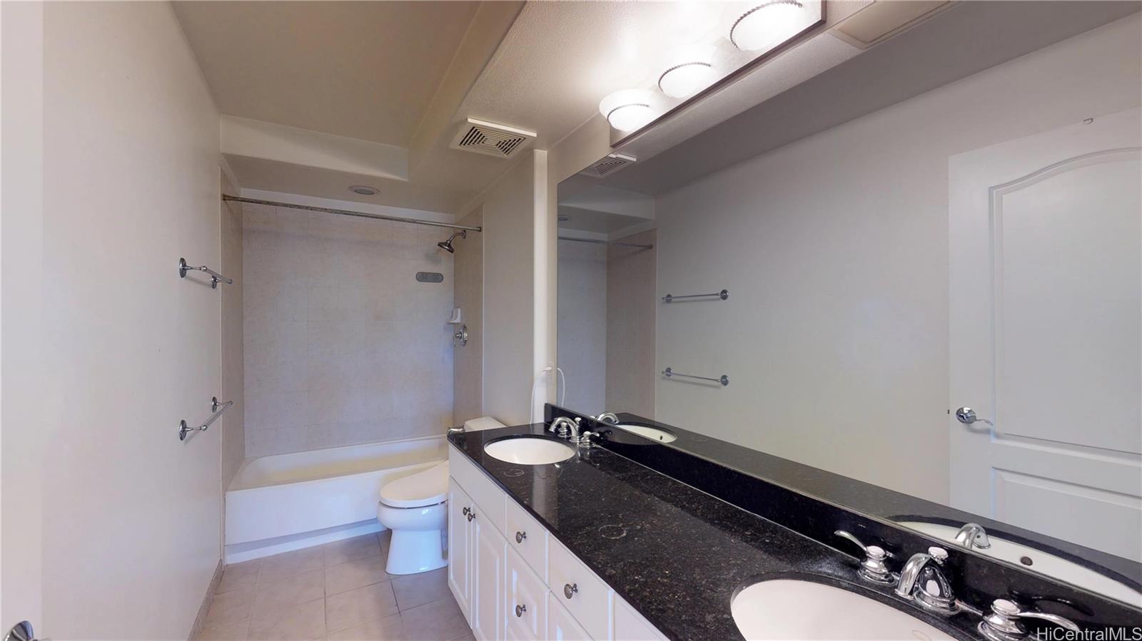 92-1033 Koio Drive, Unit M156 Kapolei, HI 96707 - Photo 14 of 20 a bathroom with a granite countertop sink toilet mirror and shower