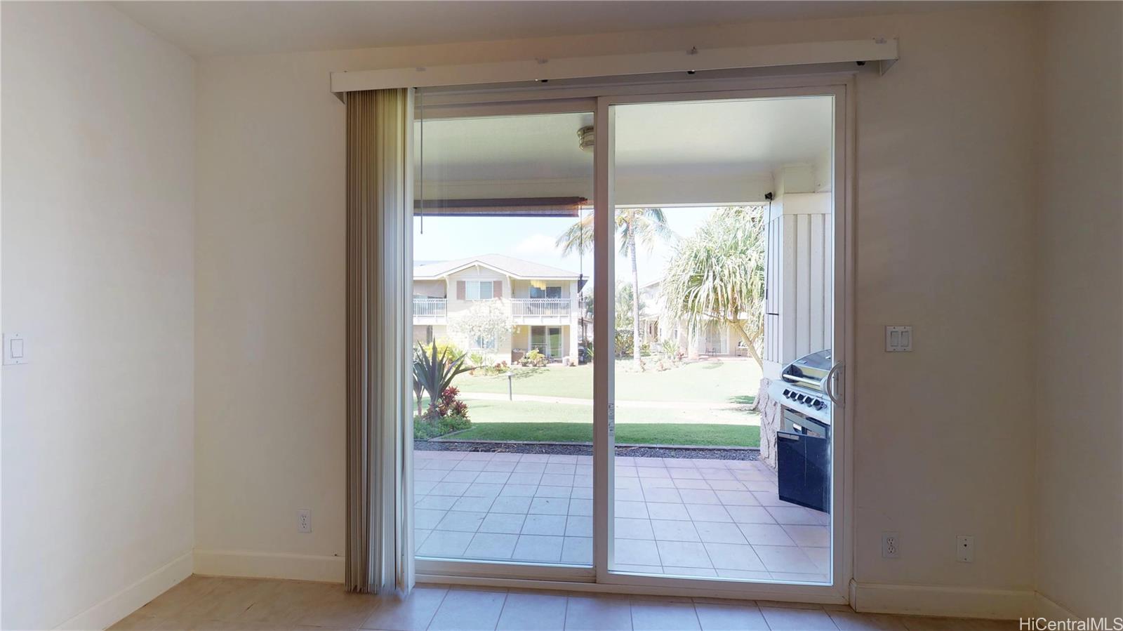 92-1033 Koio Drive, Unit M156 Kapolei, HI 96707 - Photo 18 of 20 a view of an empty room with wooden floor and a window