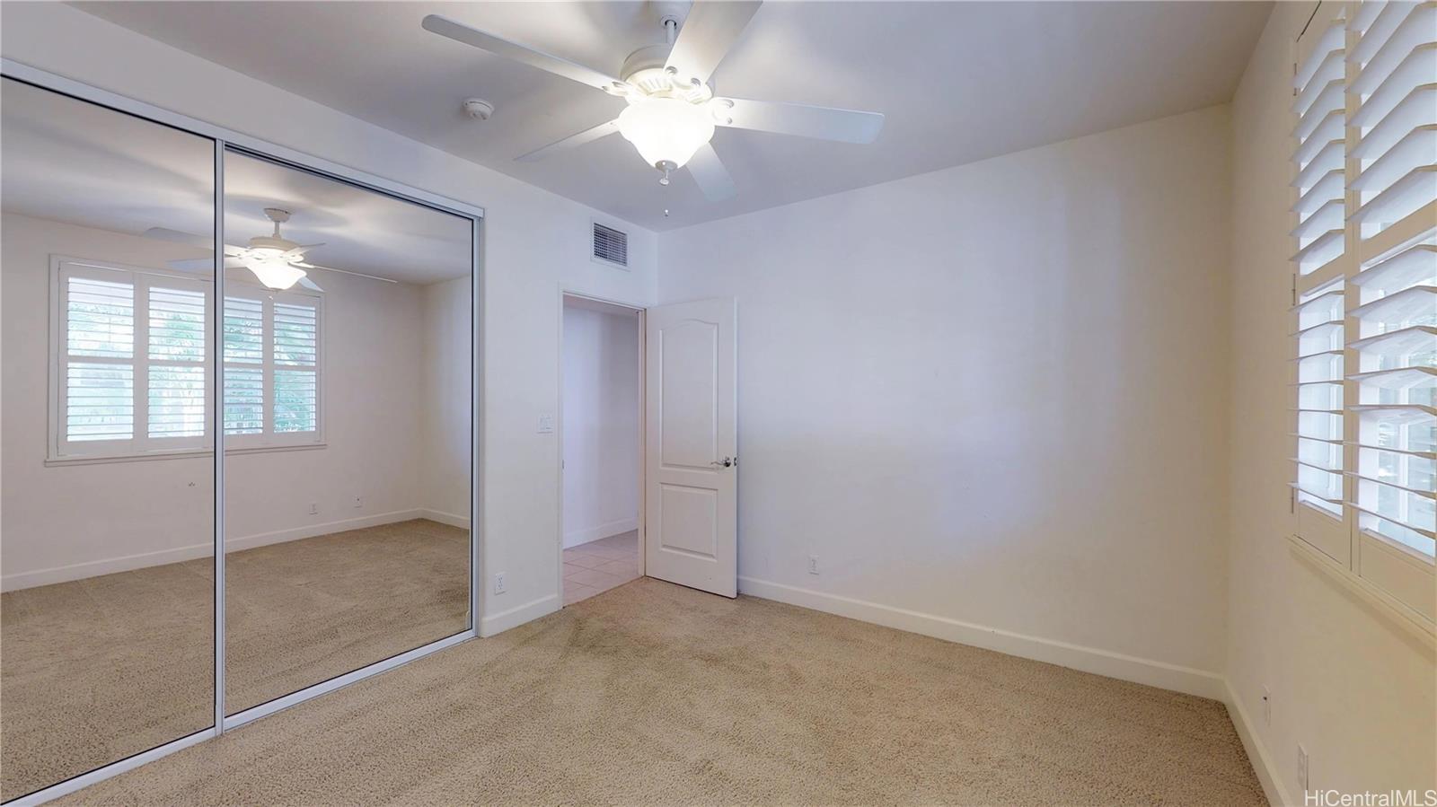 92-1033 Koio Drive, Unit M156 Kapolei, HI 96707 - Photo 7 of 20 an empty room with windows and fan