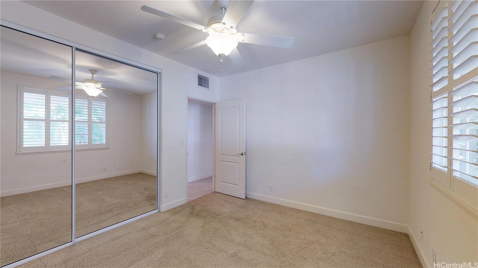 92-1033 Koio Drive, Unit M156 Kapolei, HI 96707 - Photo 8 of 20 an empty room with windows and fan