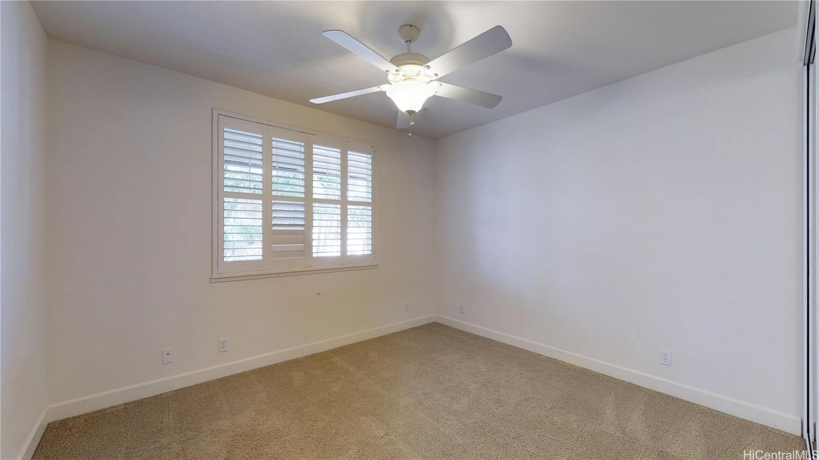 92-1033 Koio Drive, Unit M156 Kapolei, HI 96707 - Photo 9 of 20 an empty room with chandelier fan and windows