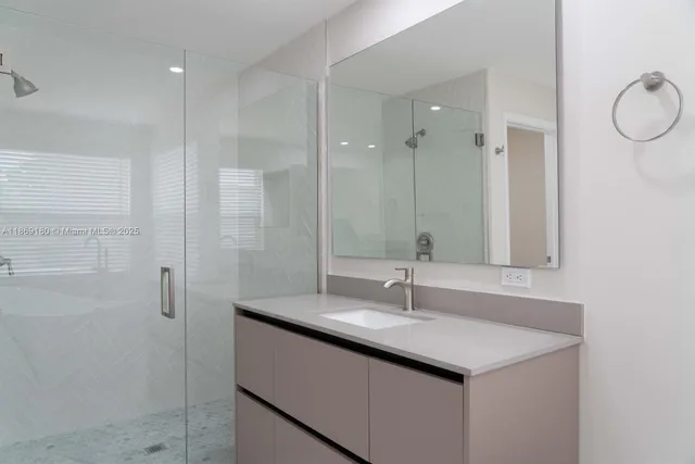 a bathroom with a double vanity sink a mirror and a bathtub