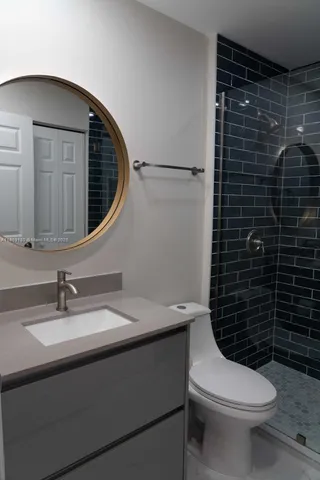 a bathroom with a shower toilet and sink