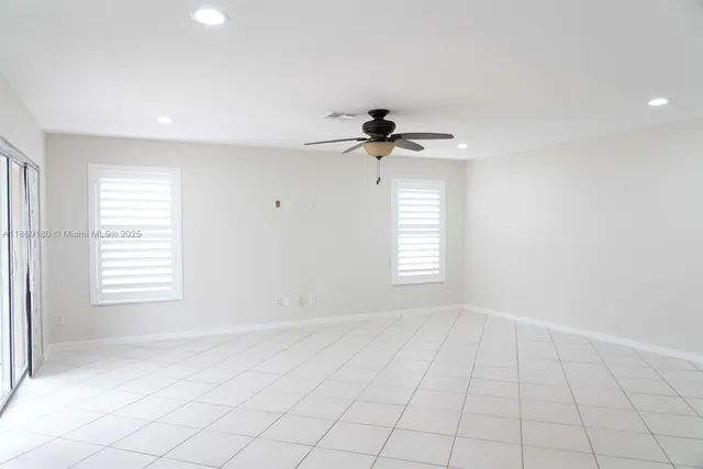 a kitchen with white cabinets and refrigerator