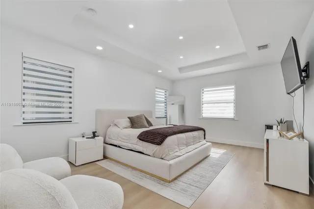 a spacious bedroom with a bed and a couch