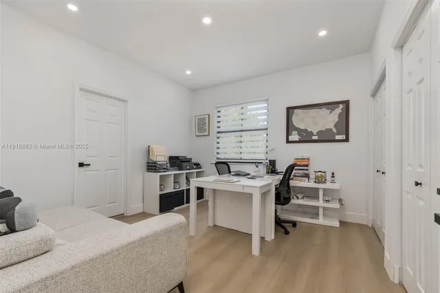 a view of a workspace with furniture and wooden floor