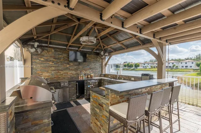 a kitchen with stainless steel appliances granite countertop a sink a counter space and cabinets