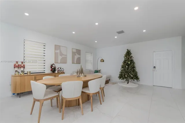 a dining room with furniture and window