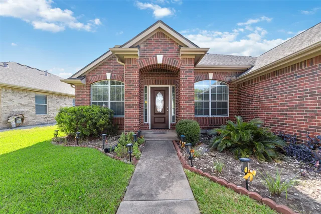 a front view of house with yard and green space