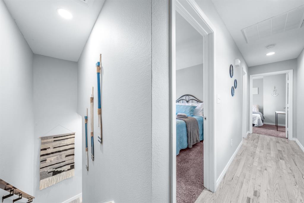 154 Wapiti Quitman, TX 75783 - Photo 21 of 31 a view of a hallway with a bedroom and wooden floor