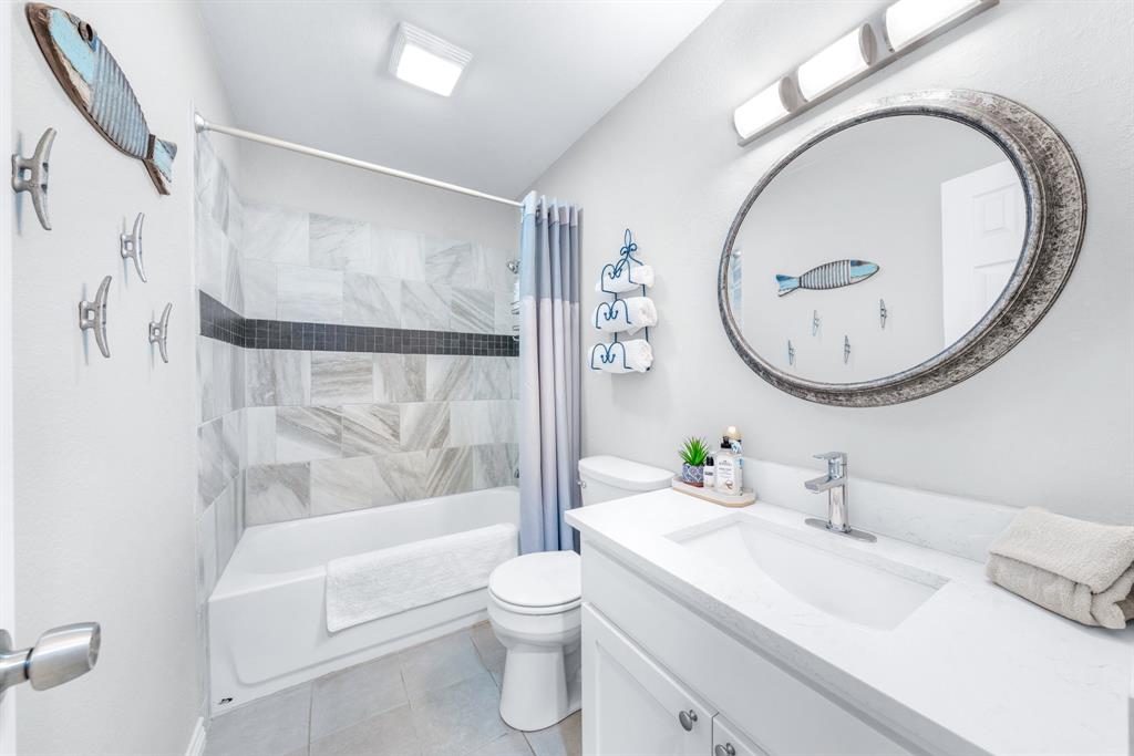 154 Wapiti Quitman, TX 75783 - Photo 24 of 31 a bathroom with a toilet a sink and a mirror