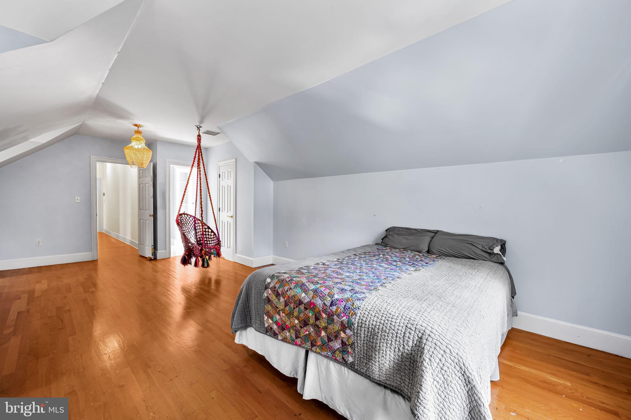 660 Greenbridge Road Brookeville, MD 20833 - Photo 30 of 56 a bedroom with a bed and a chandelier