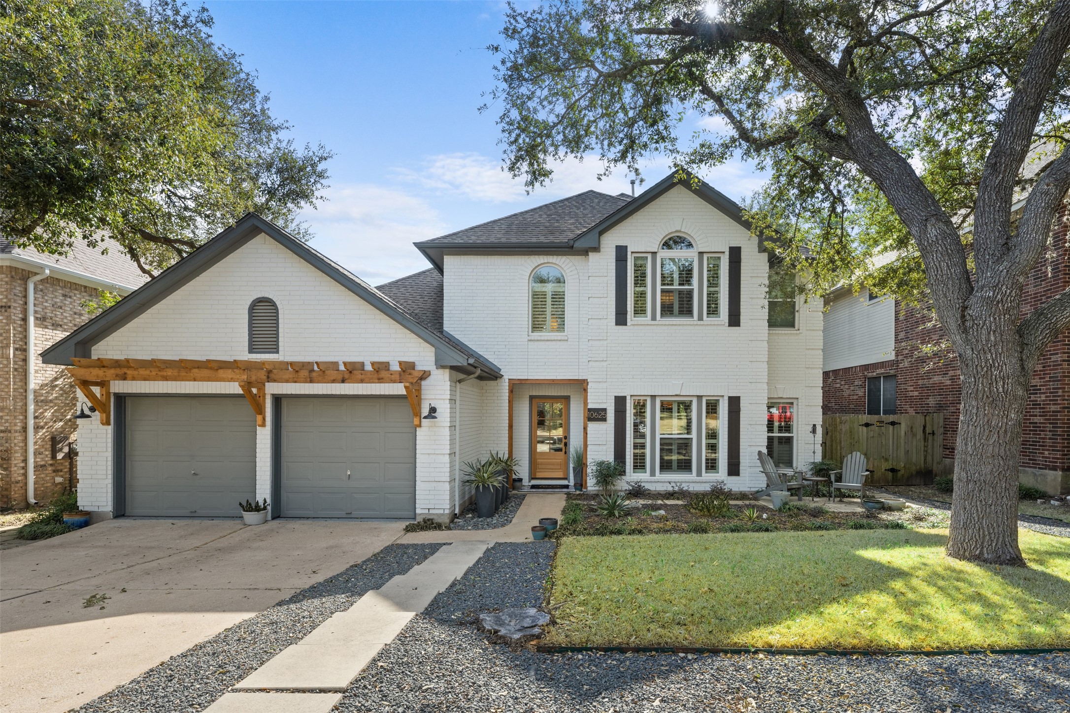 10625 Redmond Road Austin, TX 78739 - Photo 1 of 1 a front view of a house with a yard and garage
