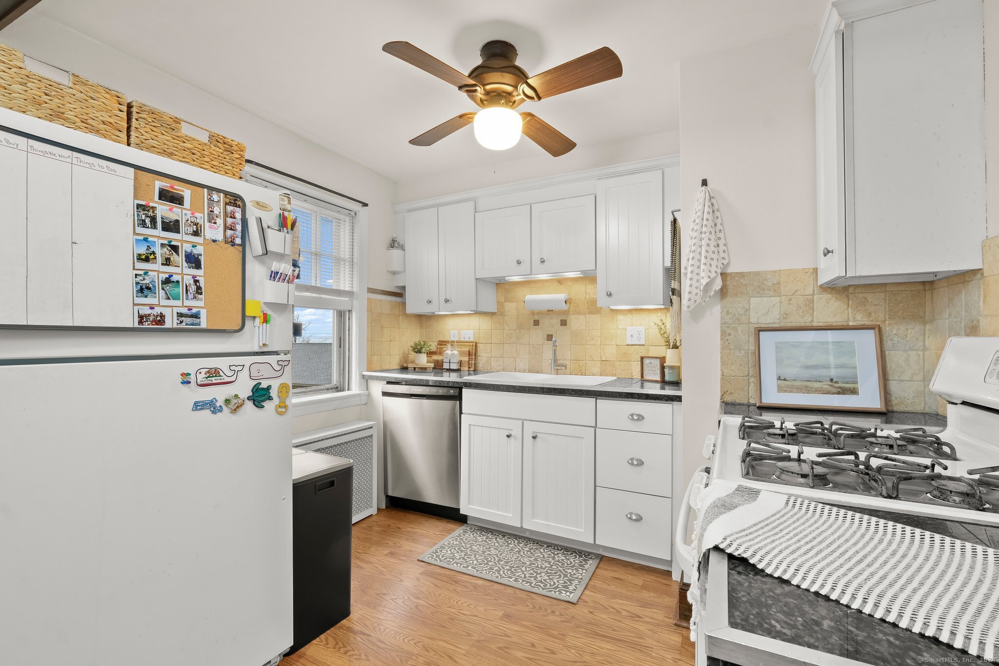 a kitchen with a refrigerator a stove a sink and cabinets