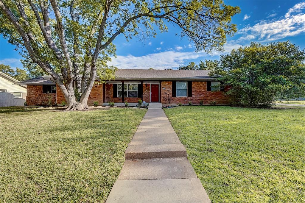 a front view of house with yard and green space