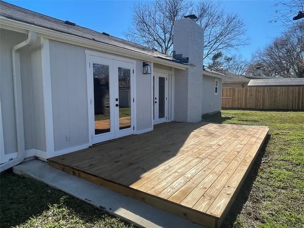 a view of backyard with roof deck