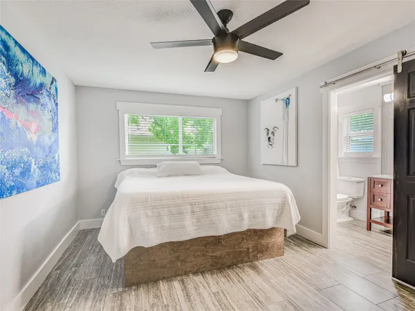 a bedroom with a bed and a window