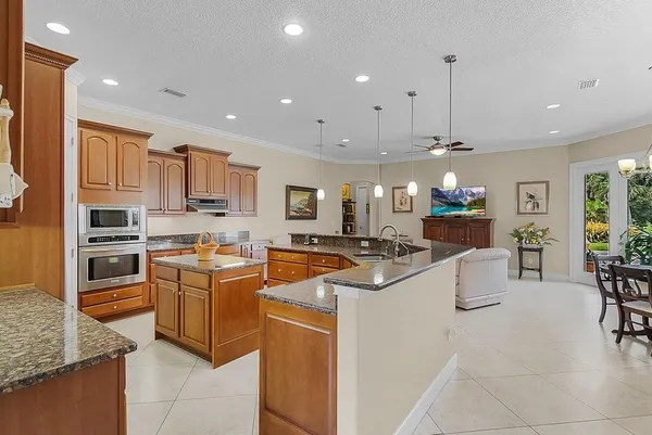 a kitchen with stainless steel appliances kitchen island granite countertop a sink and cabinets