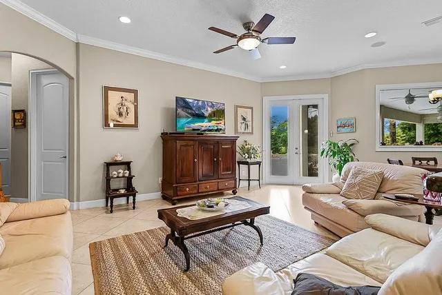 a dining room with furniture a large window and a chandelier