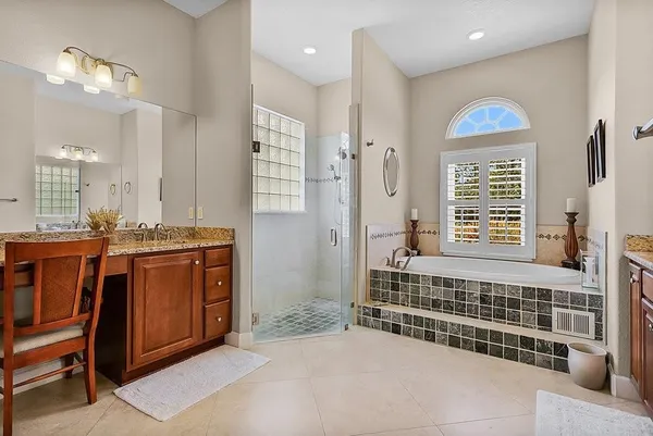 a bathroom with a granite countertop toilet sink and mirror