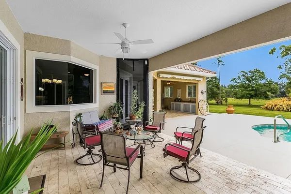 a view of a patio with dining table and chairs