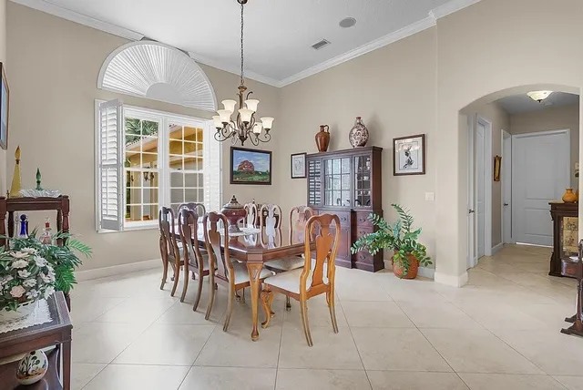 a dining room with furniture a chandelier and pool table