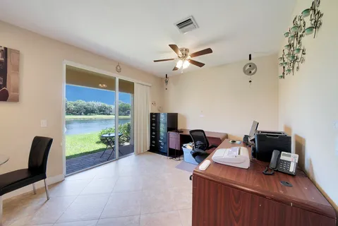 a view of a workspace with furniture and a window