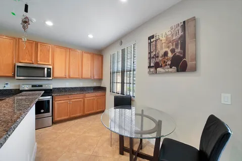 a kitchen with granite countertop a stove cabinets and microwave