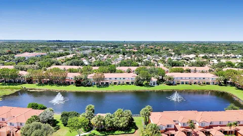 an aerial view of a city residential houses with outdoor space and lake view
