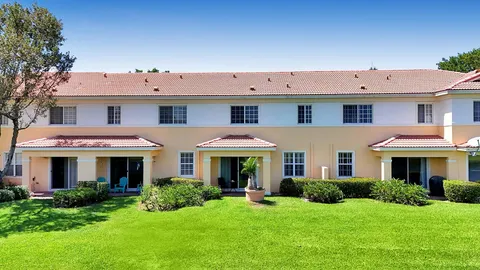 a front view of a building with a yard