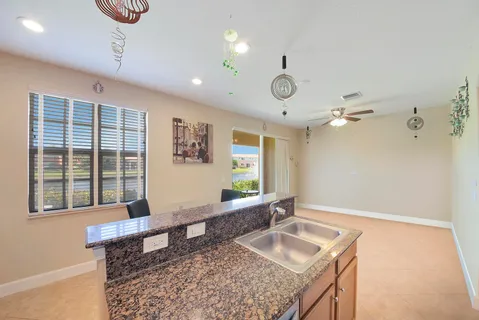 a bathroom with a granite countertop sink and a large mirror