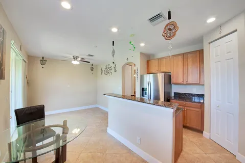 a kitchen with stainless steel appliances granite countertop a refrigerator and microwave
