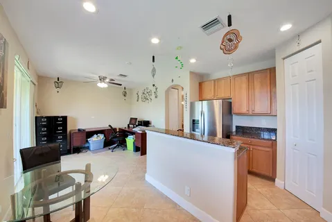 a kitchen view with stainless steel appliances refrigerator stove microwave and cabinets