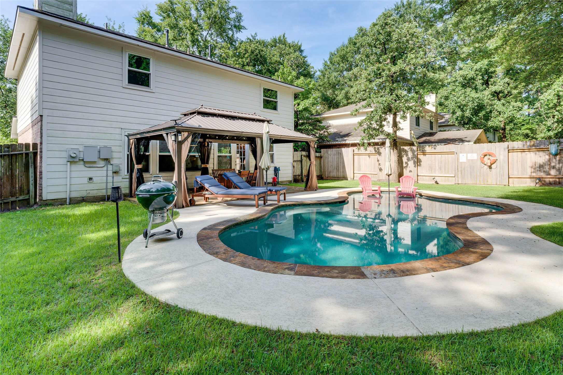 34 Steep Trail Place Conroe, TX 77385 - Photo 1 of 21 a view of a house with backyard sitting area and garden