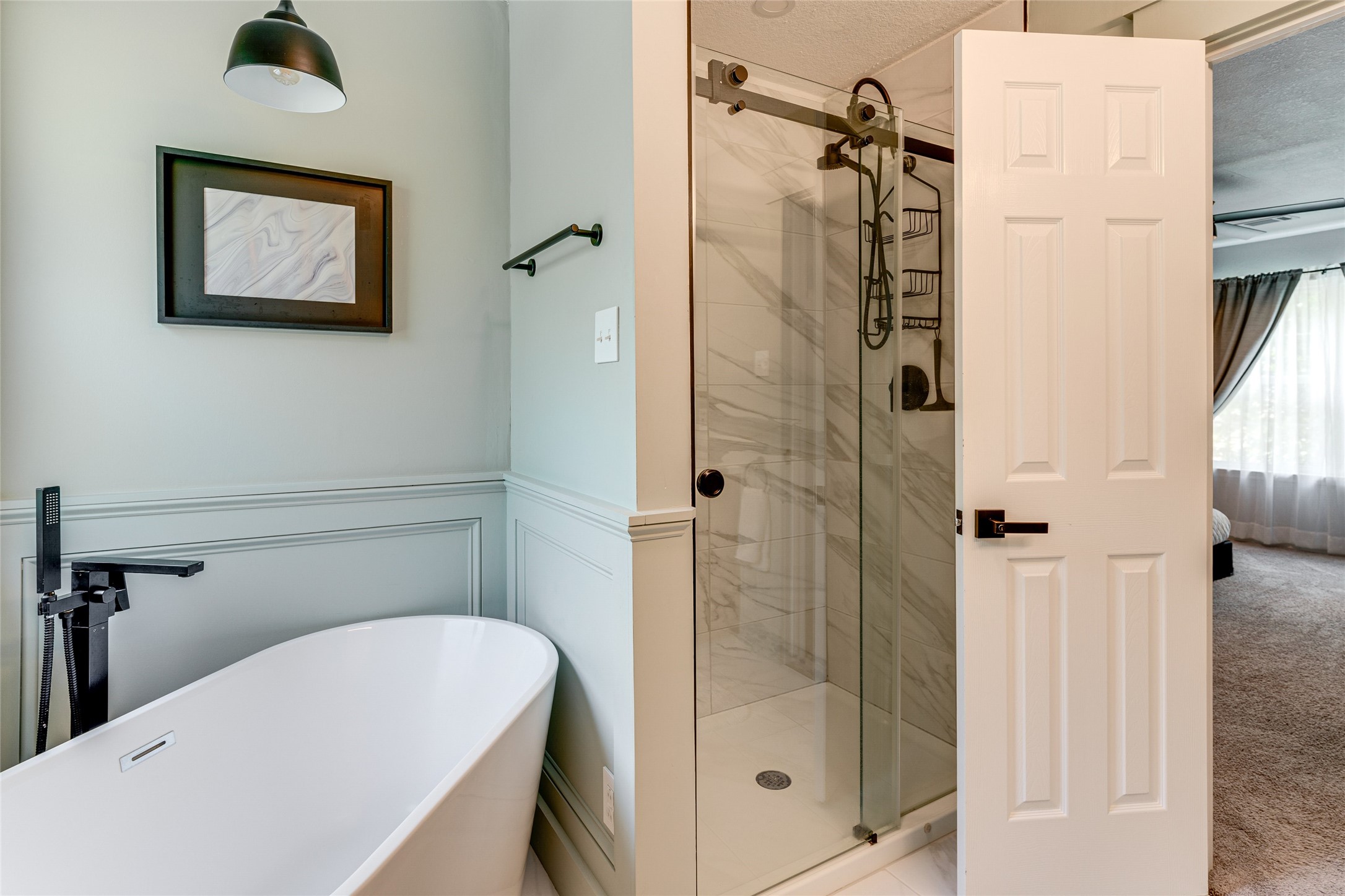 34 Steep Trail Place Conroe, TX 77385 - Photo 13 of 21 a bathroom with a tub a mirror and a shower