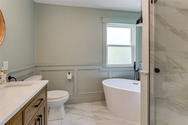 a bathroom with a sink a toilet and tub
