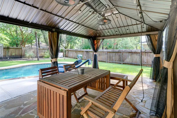 a view of a patio with a table chairs and a backyard