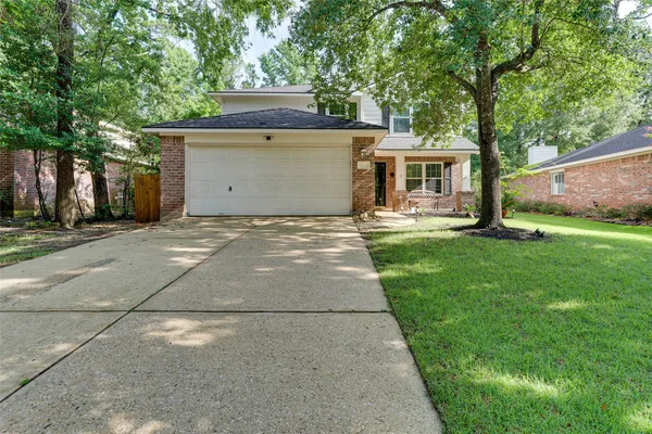 a front view of house with yard and trees