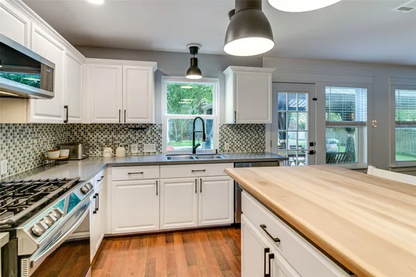 a kitchen with a sink stove and microwave