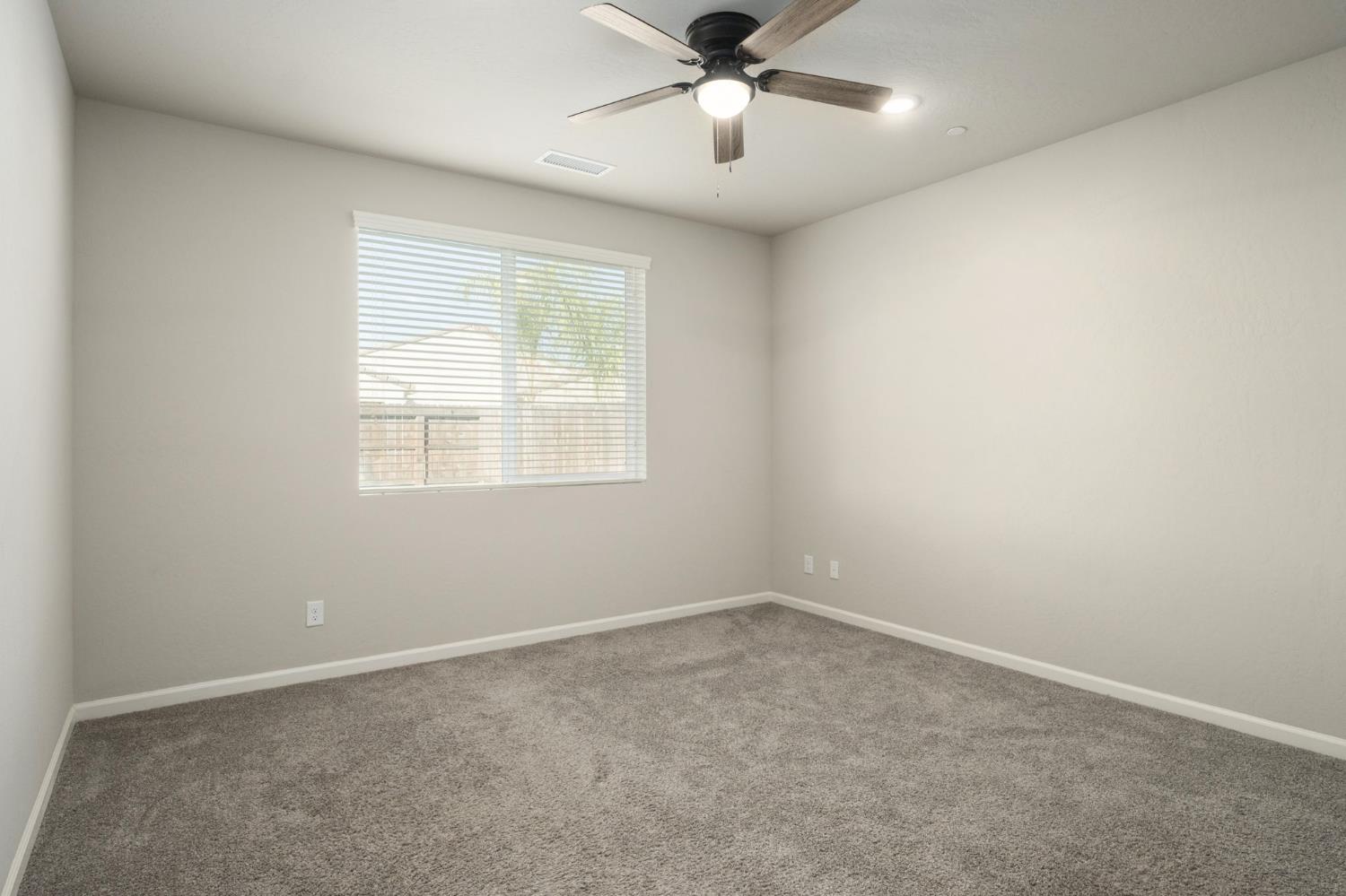 502 Traverse Drive South Madera, CA 93636 - Photo 16 of 40 an empty room with a window and a fan