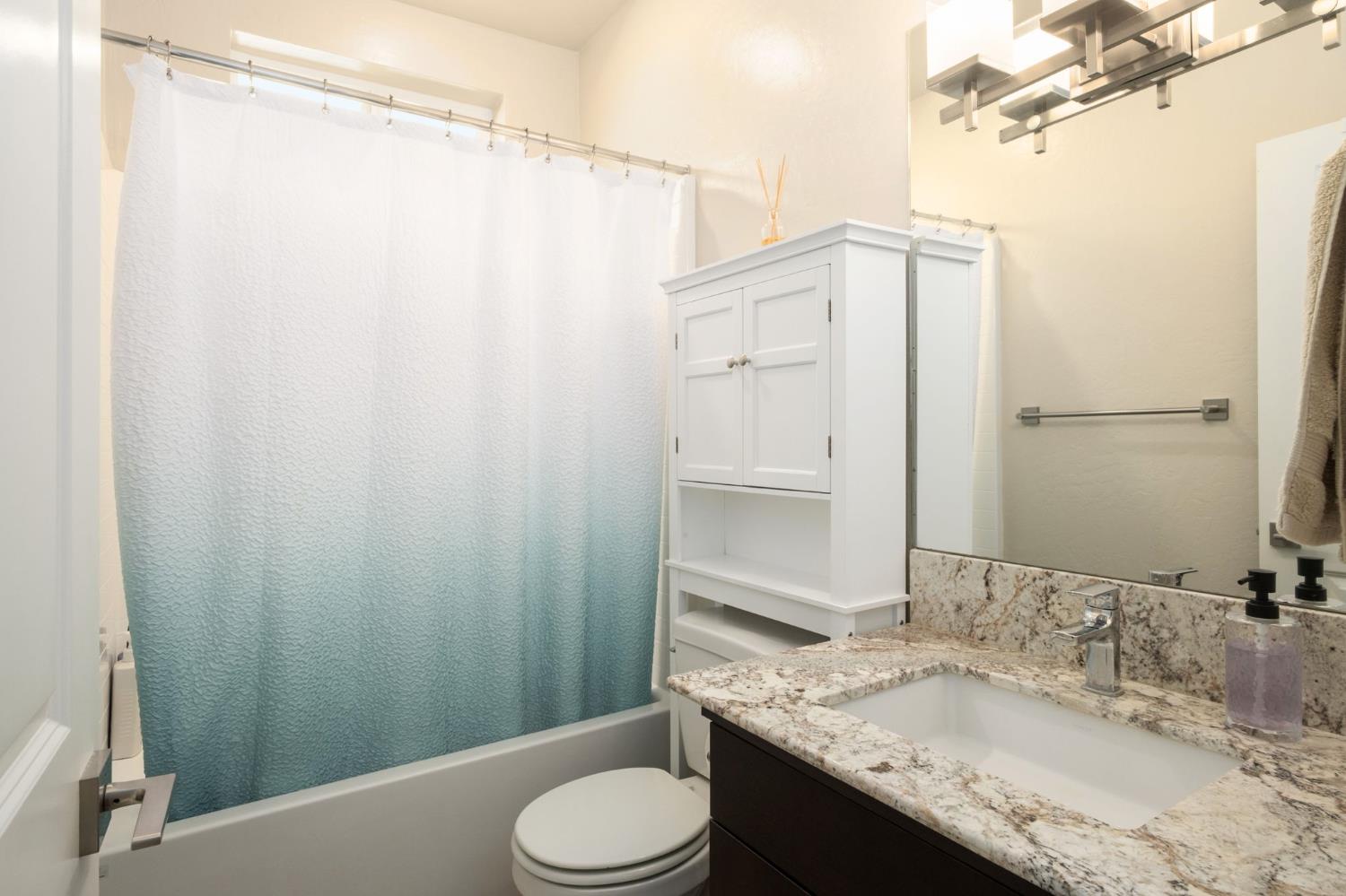 502 Traverse Drive South Madera, CA 93636 - Photo 20 of 40 a bathroom with a granite countertop sink toilet and shower