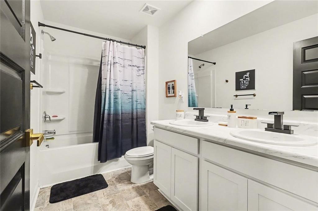 3732 Chevington Court Southeast Atlanta, GA 30354 - Photo 31 of 38 a bathroom with a double vanity sink toilet mirror and shower