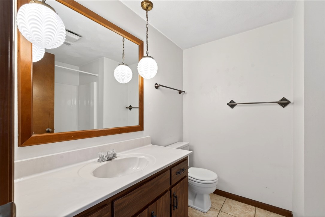 7988 McCool Road Greenville, OH 45331 - Photo 17 of 50 This bathroom features a single vanity, a toilet, and a combination shower/tub for daily comfort.