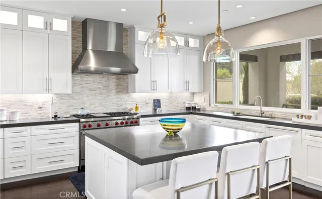 a kitchen with a sink a stove and cabinets